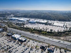 Aerial view of a retail center with parking areas, roads, and surrounding properties relevant to a due diligence survey